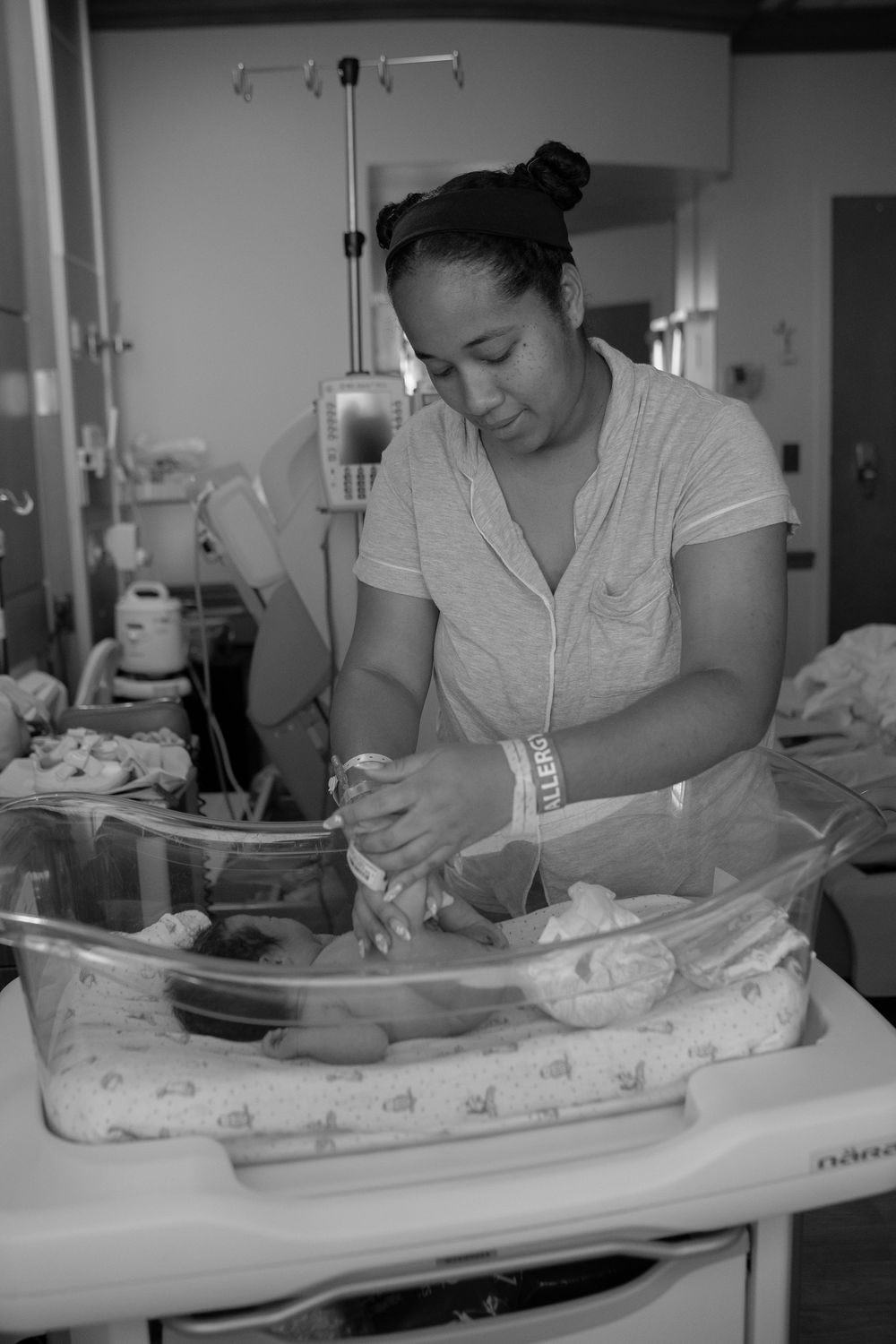 Black and white photos show someone caring for an infant on a hospital bed.