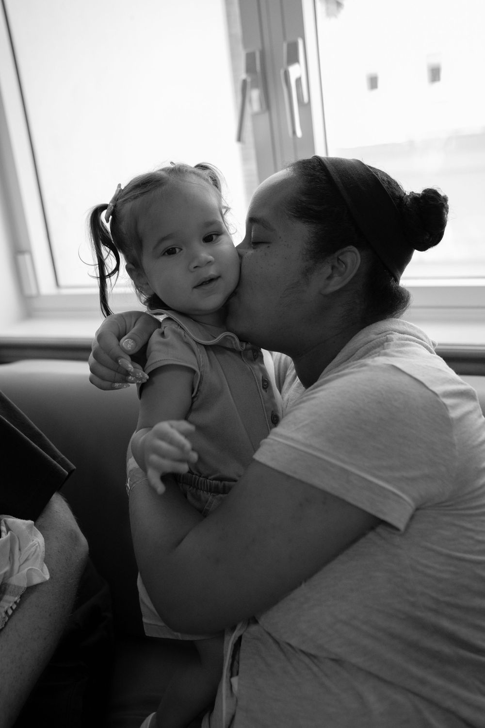 Black and white photo series showing tender moments of affection and bonding between parent and infant.