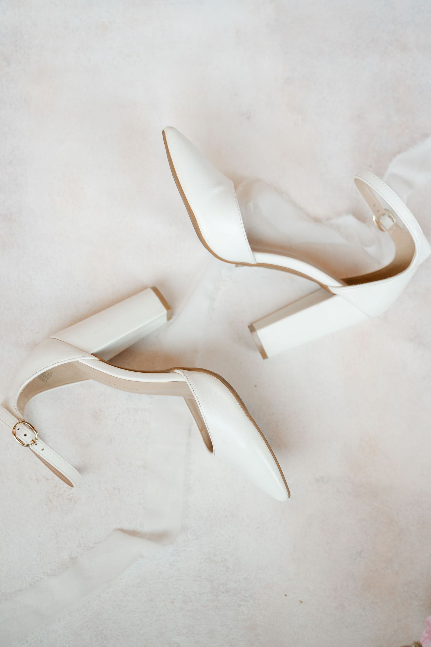 A sequence of five images showing the progressive folding of white paper into an origami bird shape against a light background.