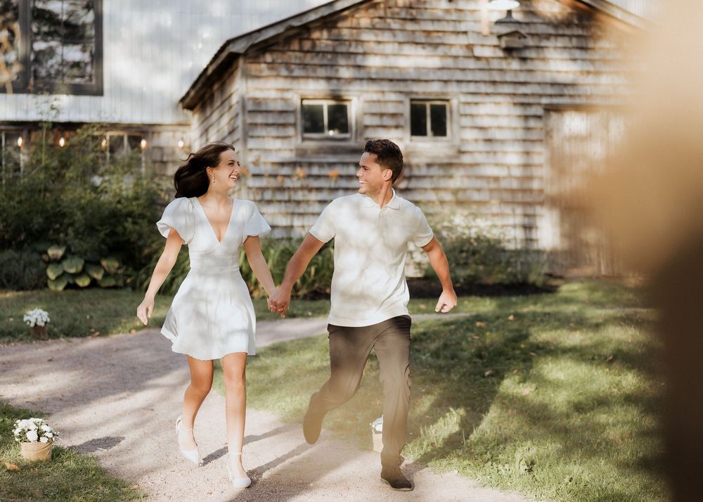 bride and groom walk hand in hand during engagement photos before surprise wedding ceremony in Moncton New Brunswick