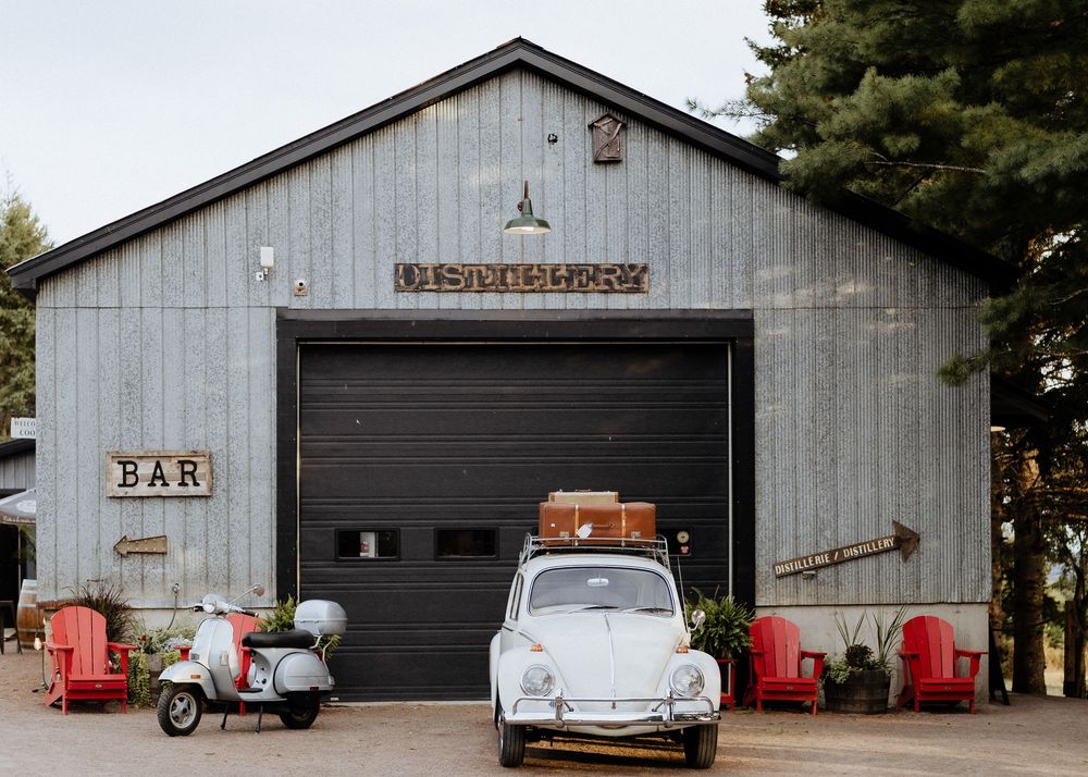 Crooked River Distillery charming wedding venue in Moncton, NB. Vintage car, vespa scooter, classic wedding photography packages