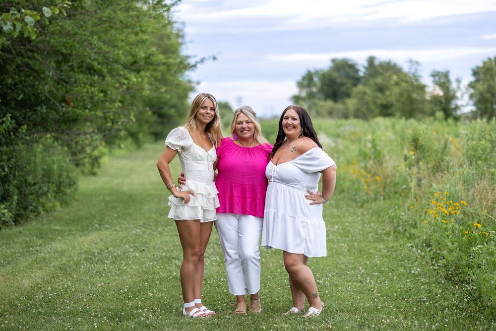 Springfield, IL Photographer captures a mom with her daughters smiles during a photo session at Centennial Park in Springfield, IL