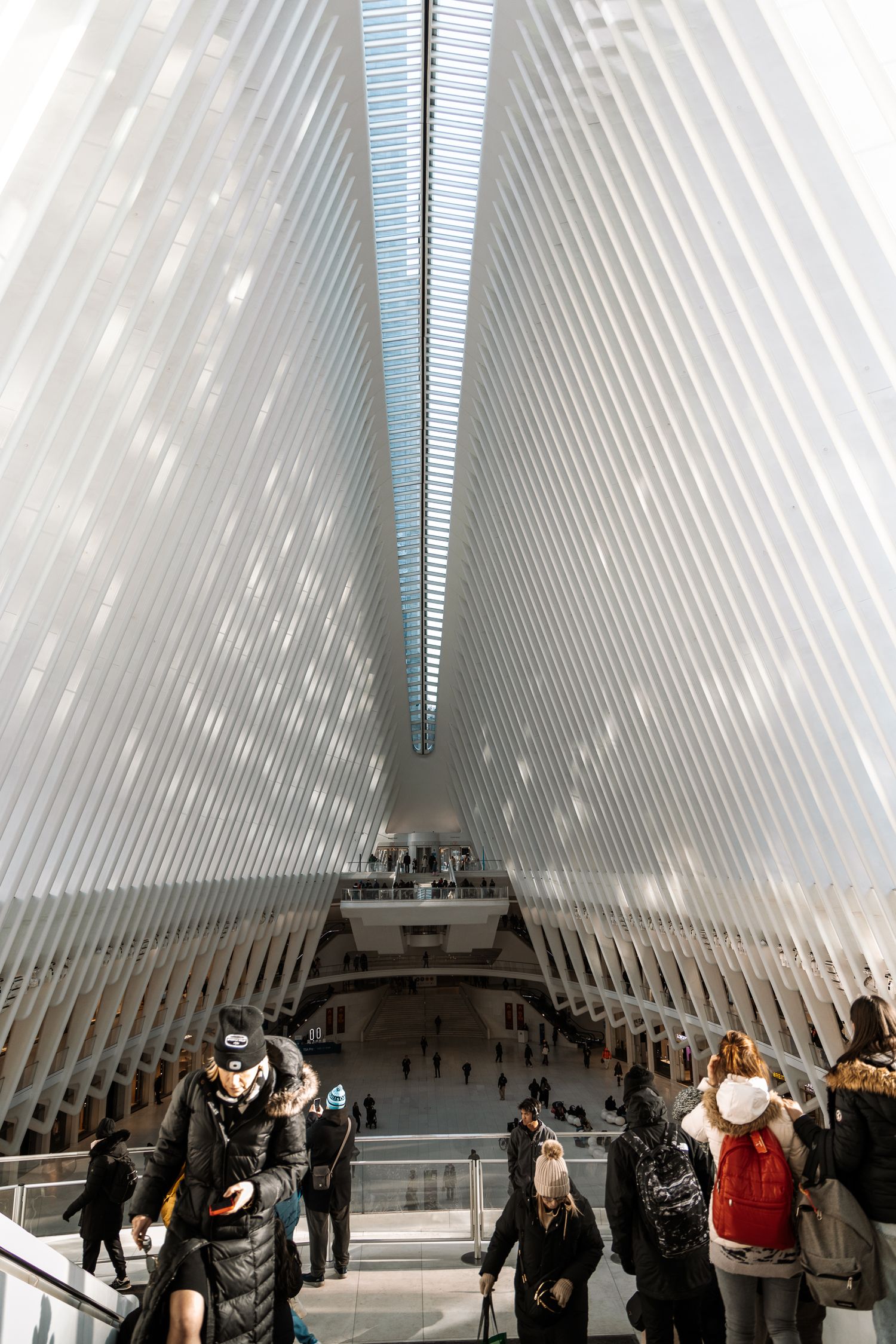 Interior view of white ribbed transit hub with natural light streaming through skylights.