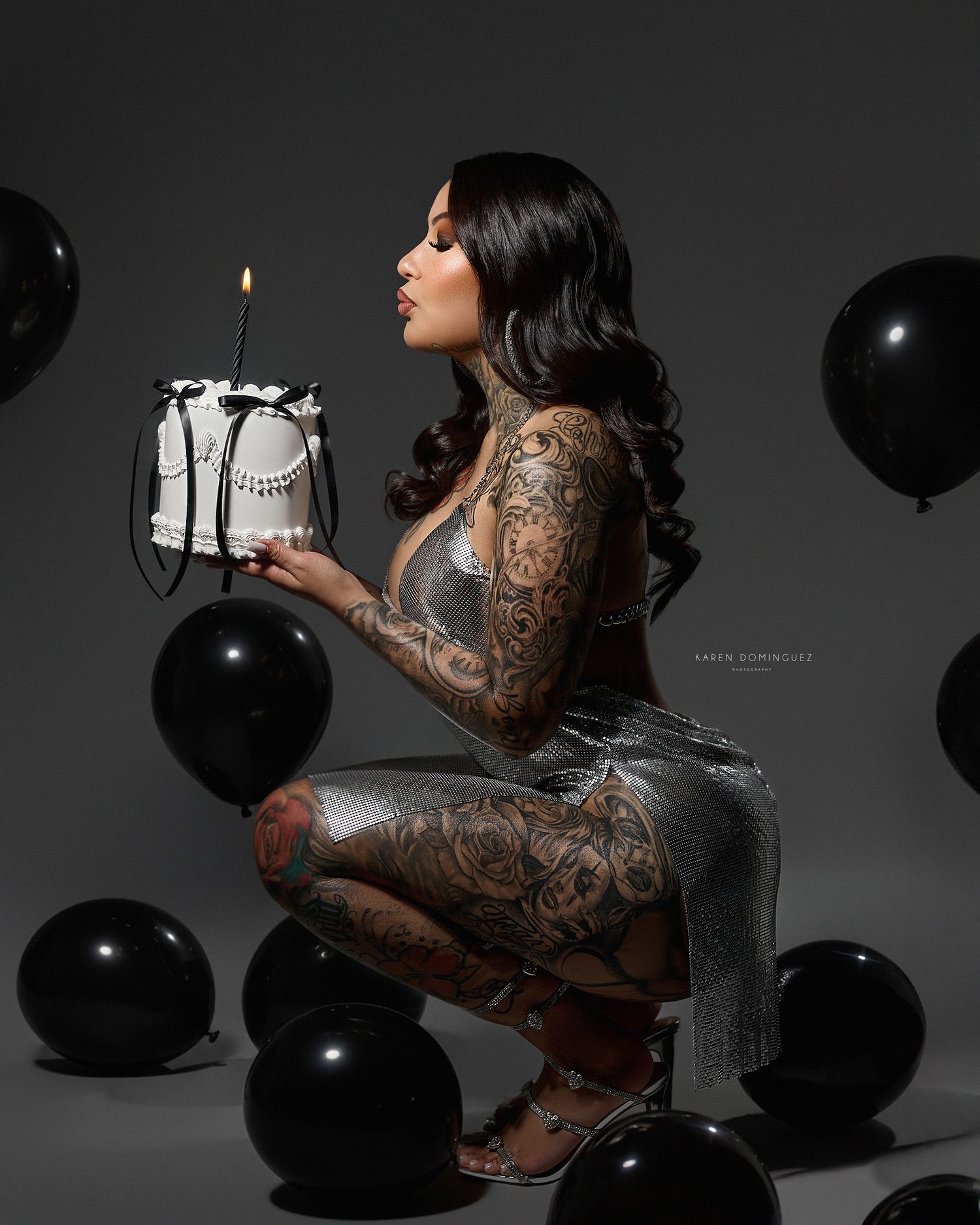 Artistic black and white photo series showing a person in sheer lace posing with black balloons against dark backdrop.