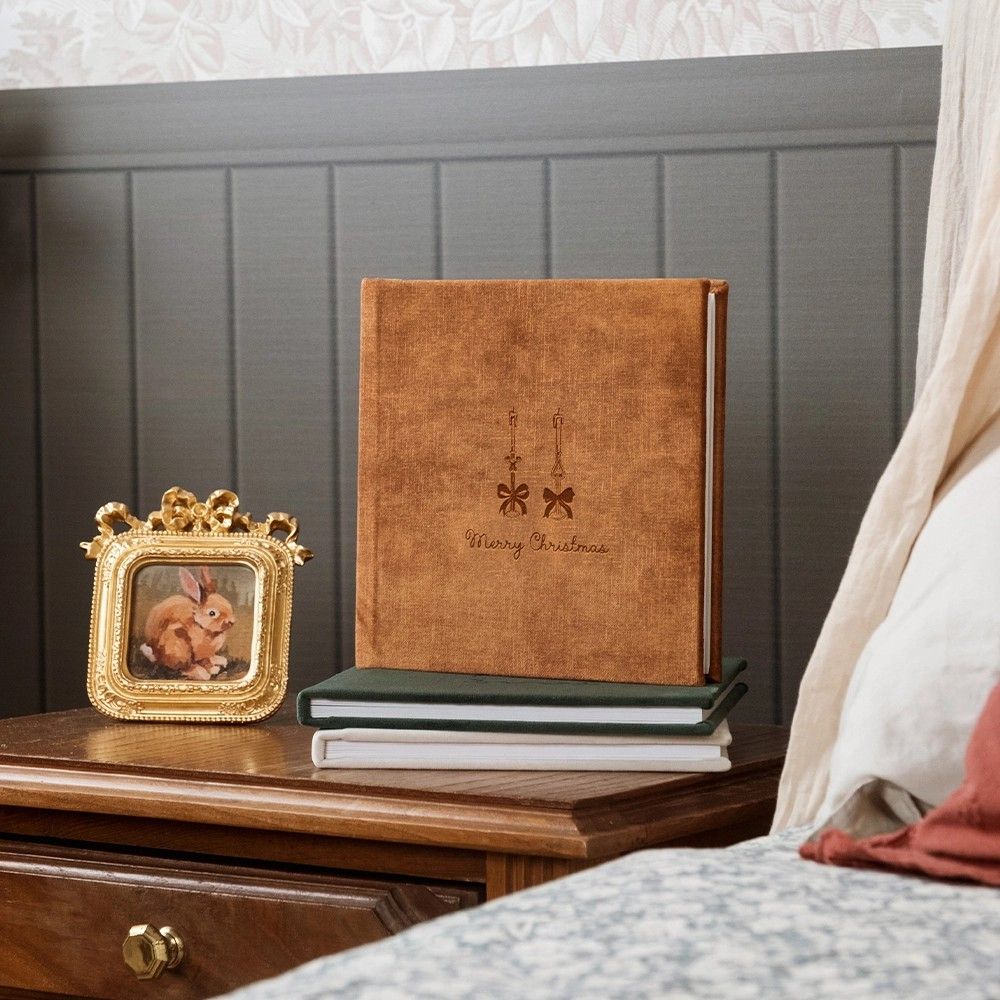 A series of wall-mounted wooden headboards with decorative gold accents in a retail showroom setting.