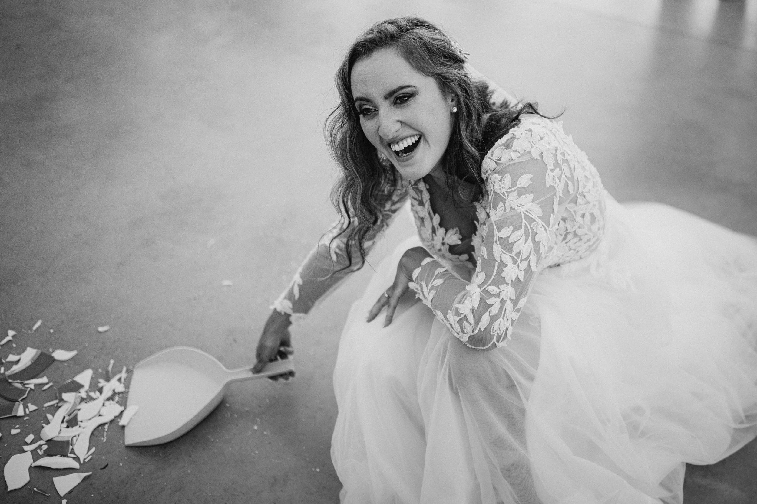 Black and white portraits of a bride in a lace wedding dress showing joyful expressions.