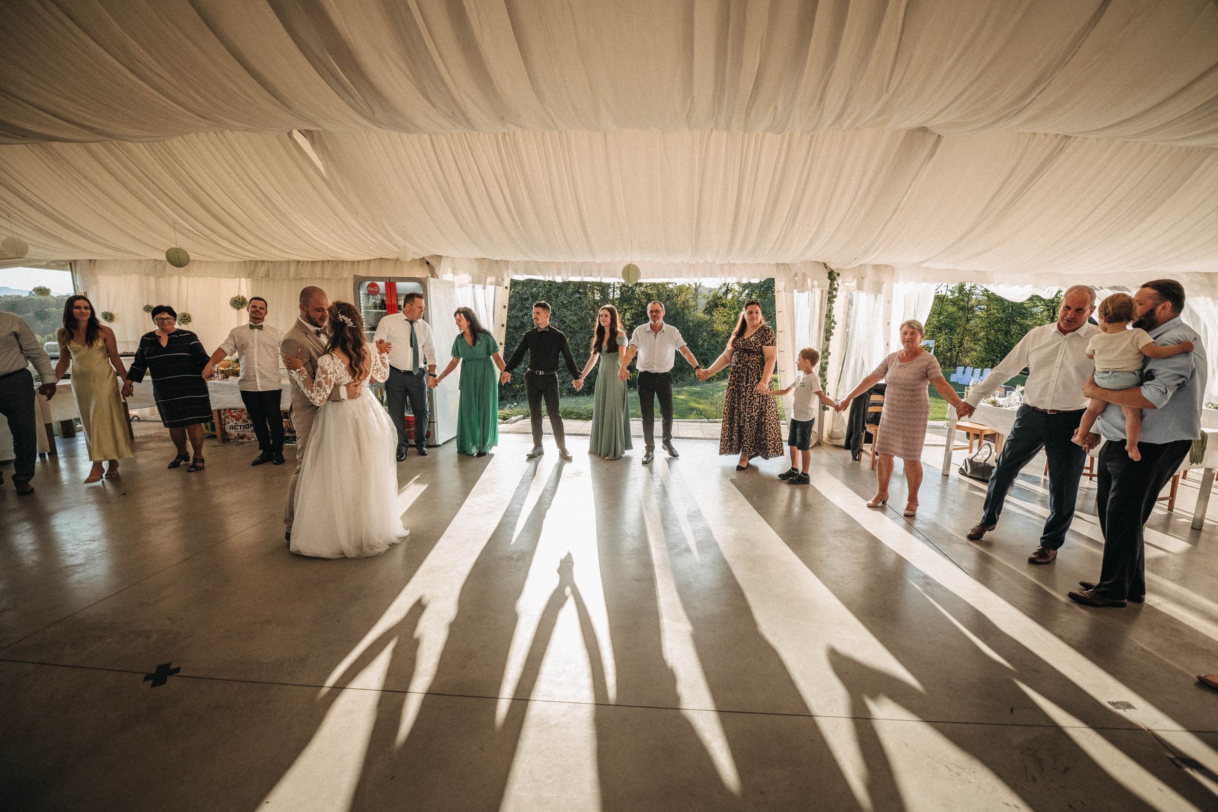 Sunlight streams through windows onto an empty reception dance floor.