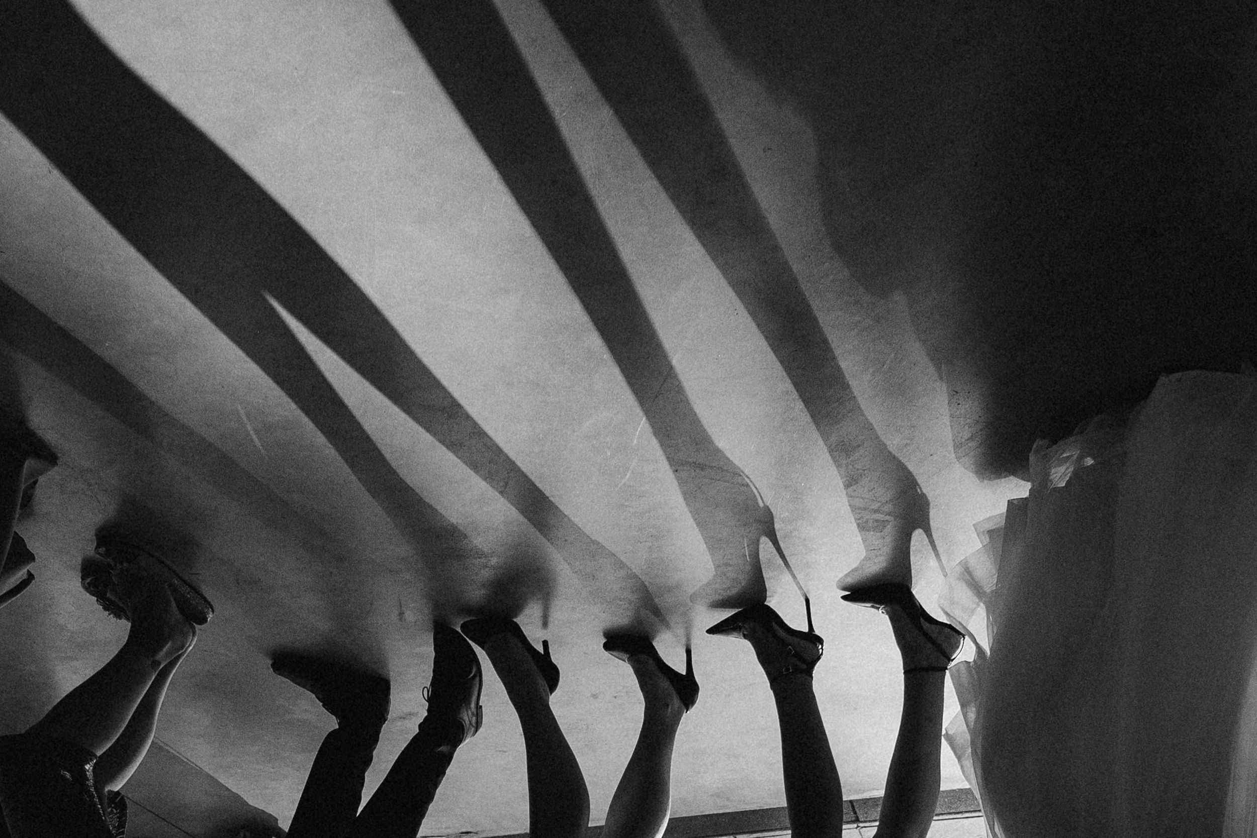 Artistic black and white silhouette of dancers at a wedding reception.