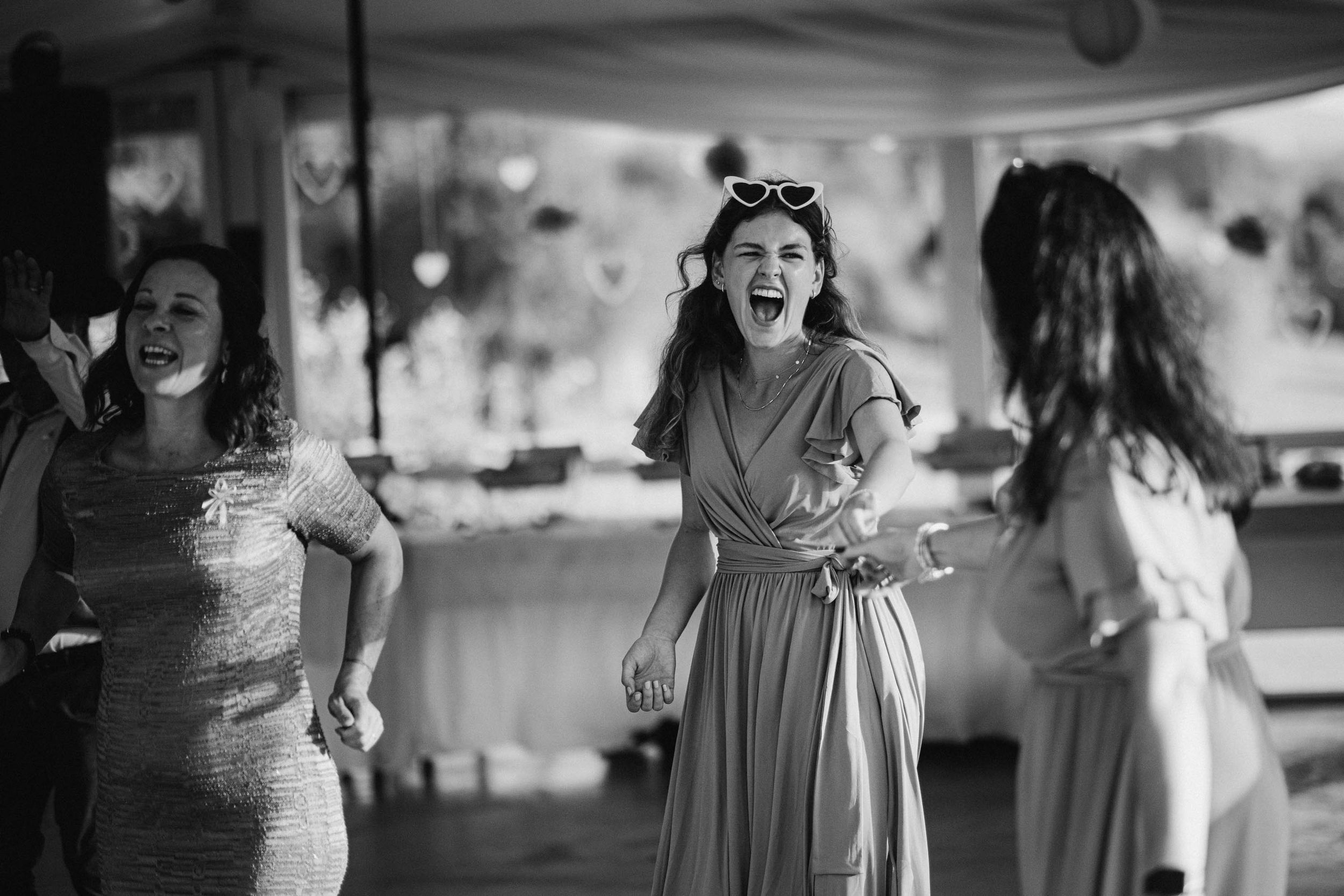 Guests enjoying themselves and dancing during a wedding reception celebration.