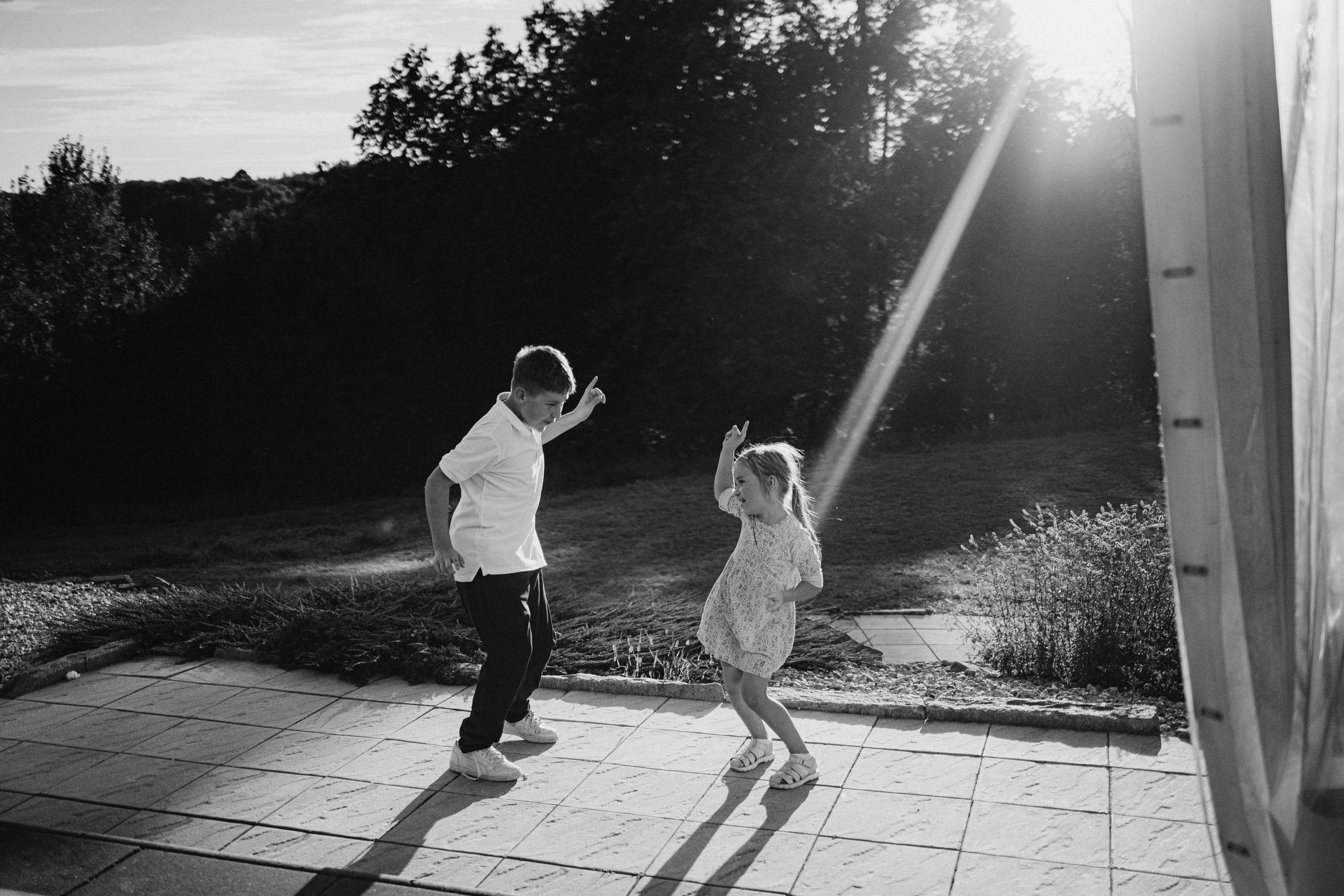 Silhouettes of people dancing in sunlight streaming through windows.
