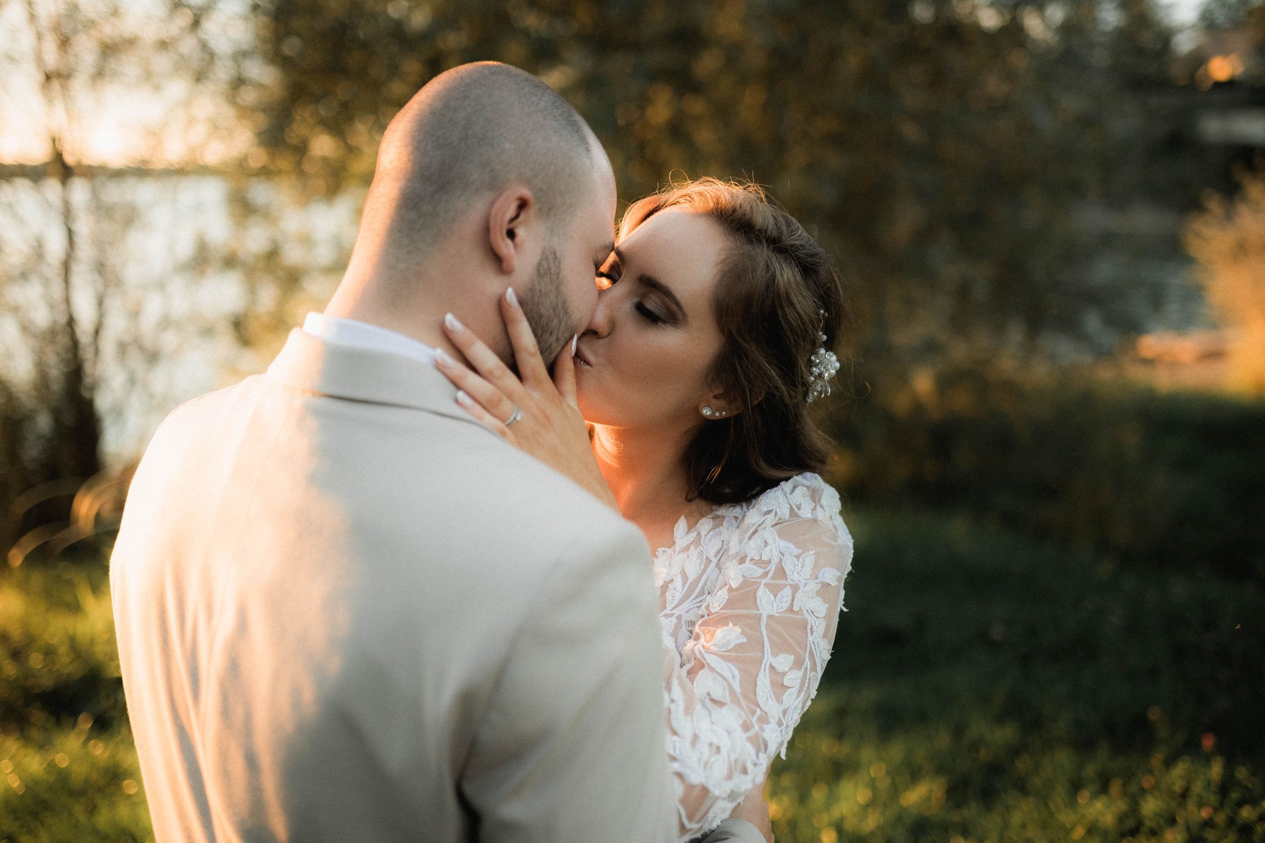 Golden hour wedding portrait capturing intimate moment between newlyweds.