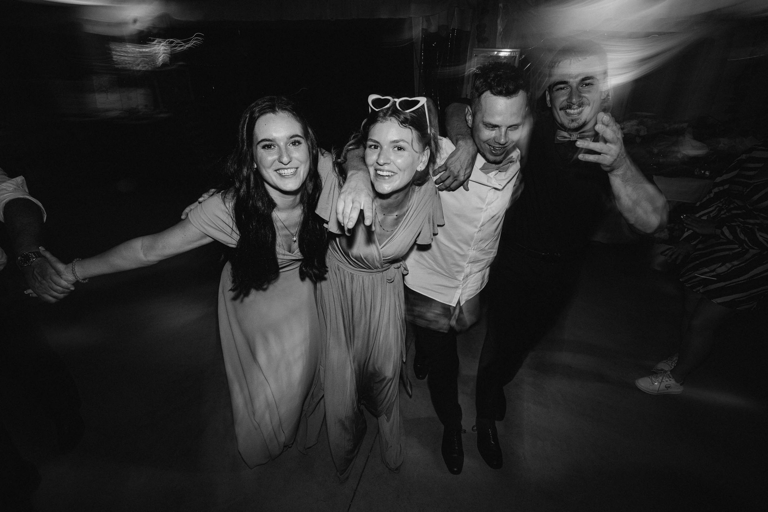 Dark reception party photos showing guests dancing and celebrating.