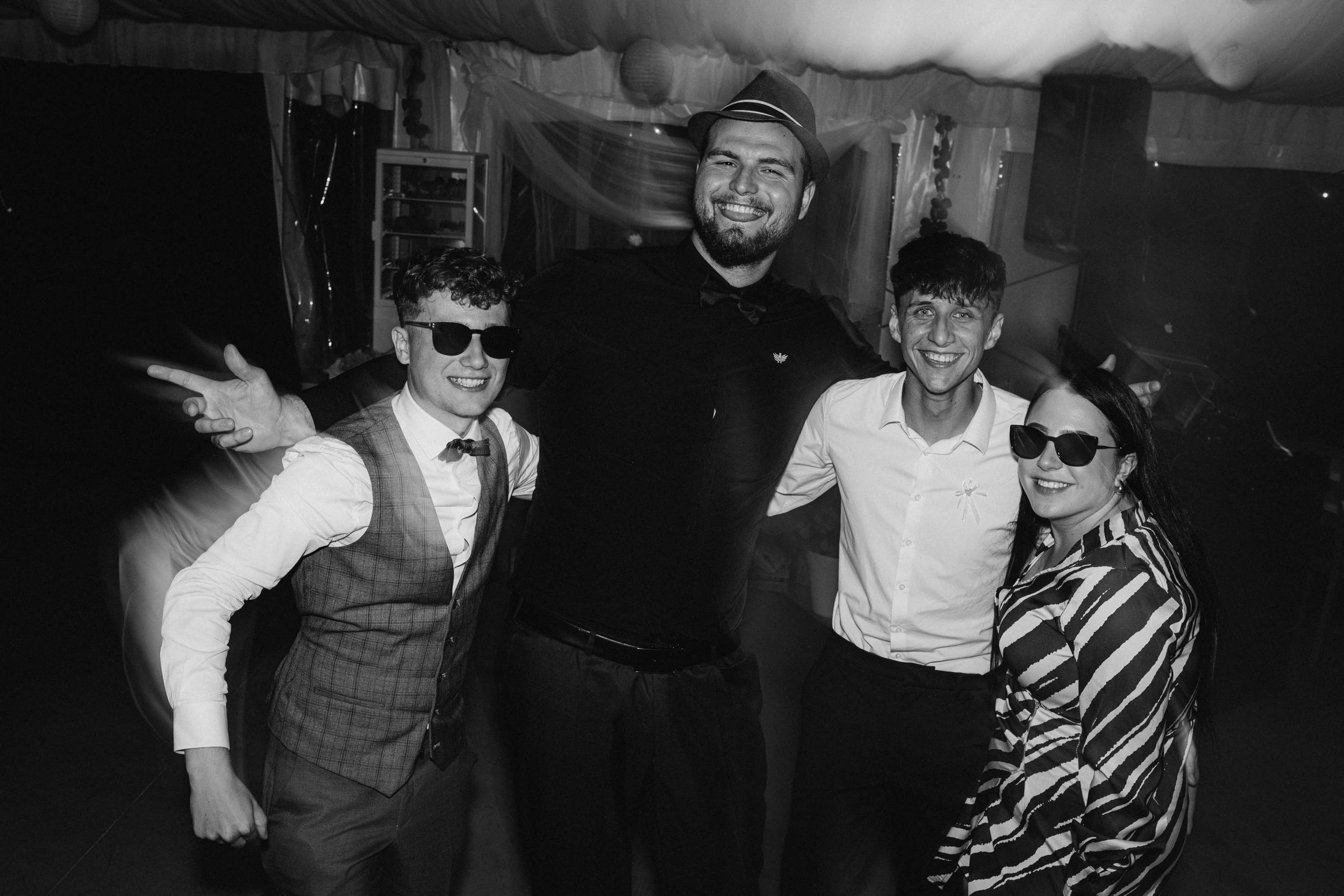 Black and white party photos capturing lively dance floor moments at a wedding reception.
