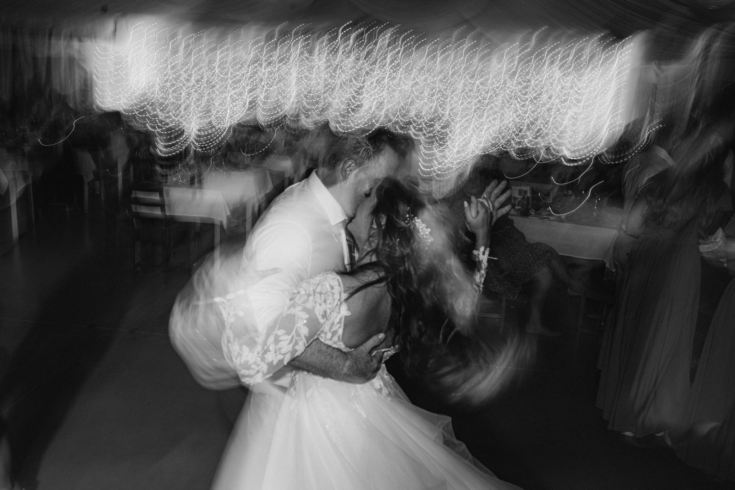 Artistic black and white shots of wedding reception dance floor celebrations.