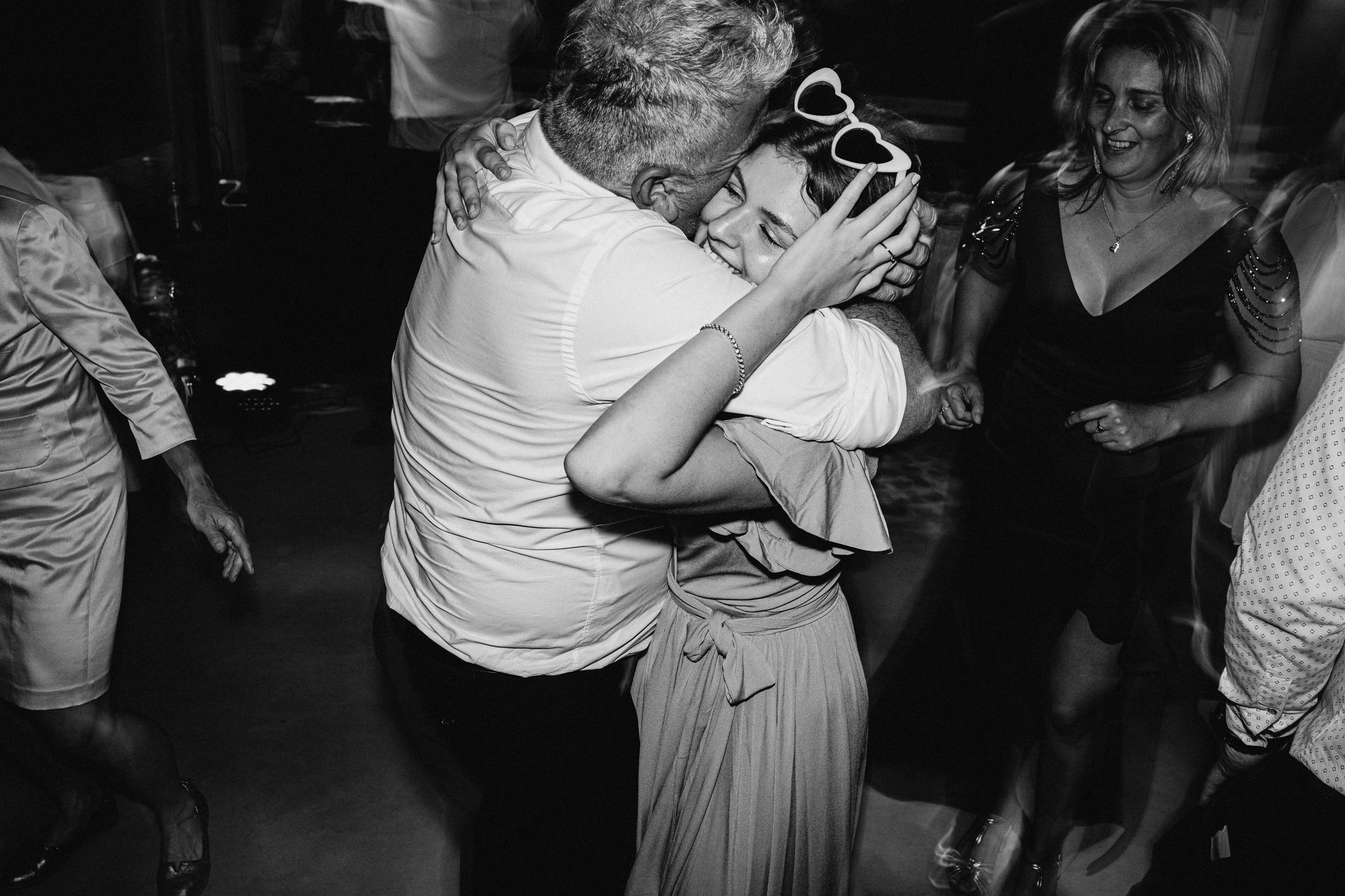 Wedding party dancing and having fun on the dance floor during reception celebrations.