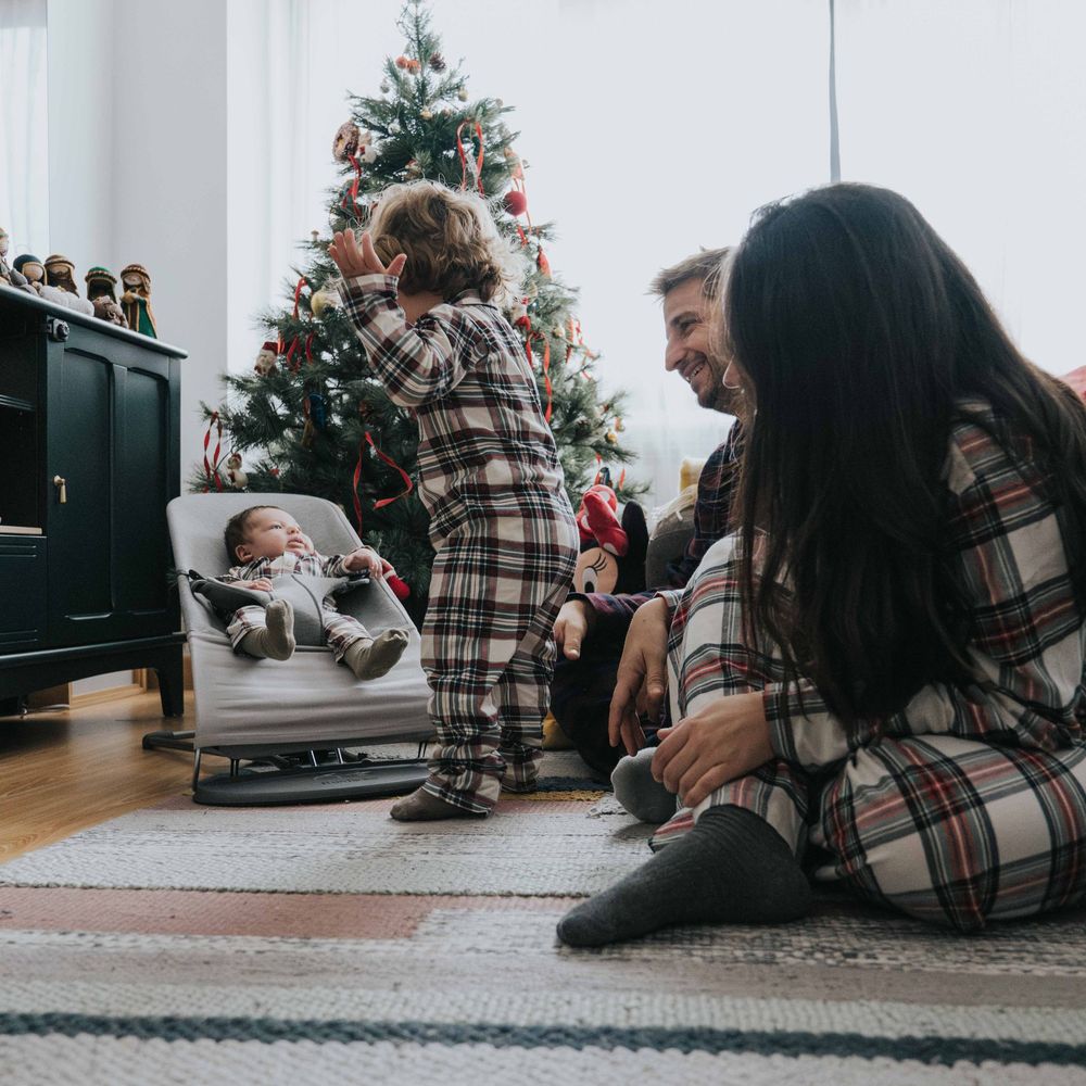 A series of photos showing people sitting by a decorated Christmas tree in a cozy living room setting.