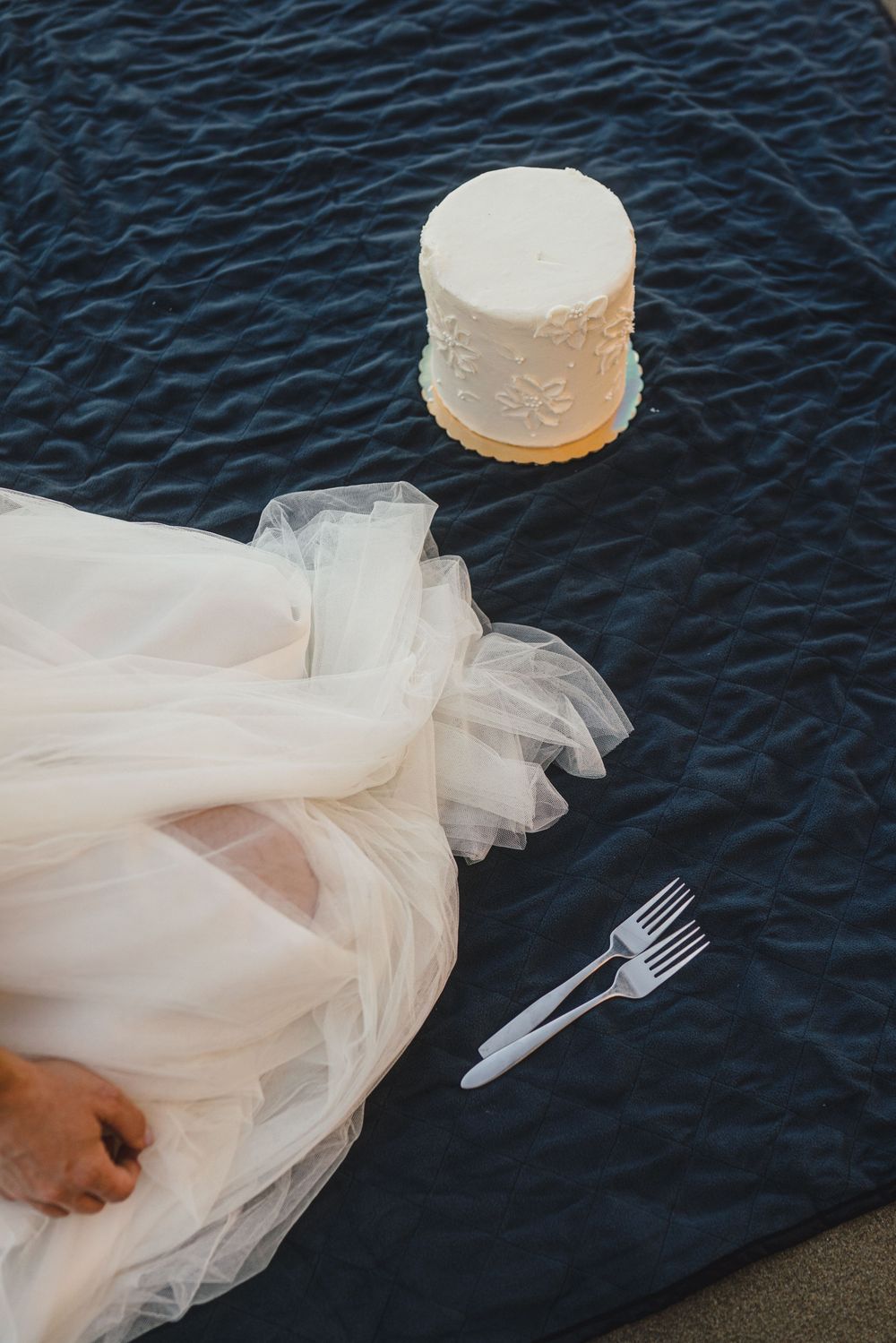 A flowing white wedding dress skirt billows gracefully against dark rippling water in a series of artistic photos.