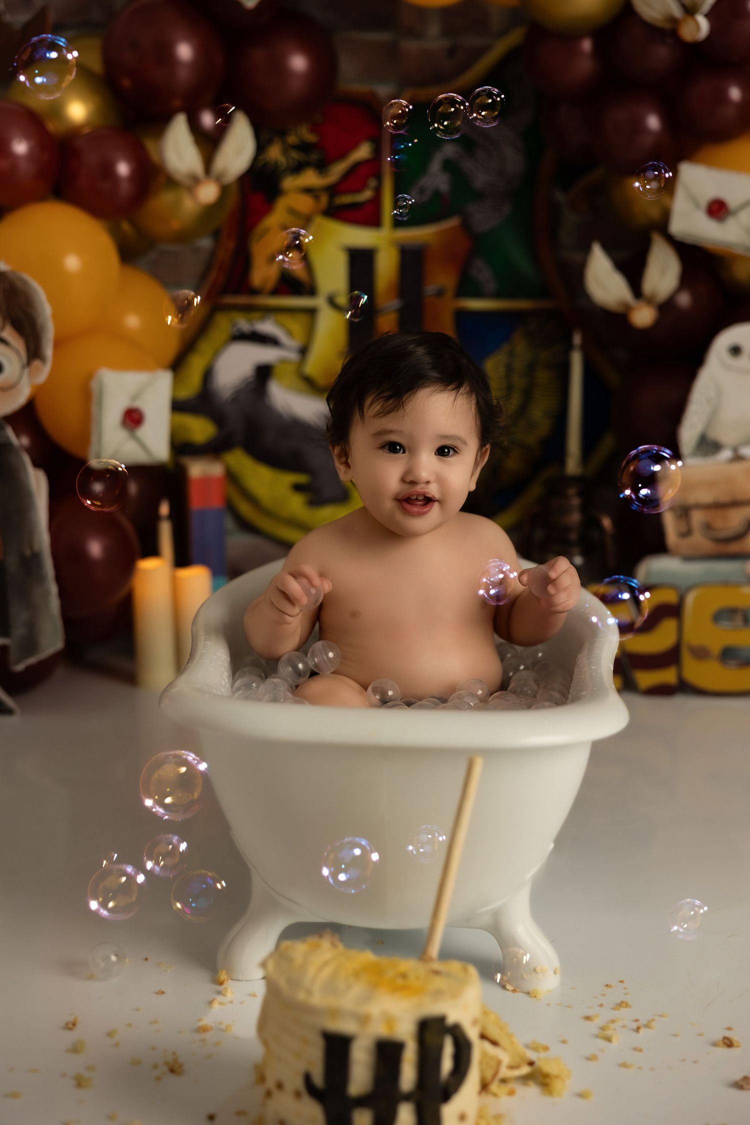 Harry Potter themed bath photoshoot with bubbles, magical decorations and a small bathtub prop.