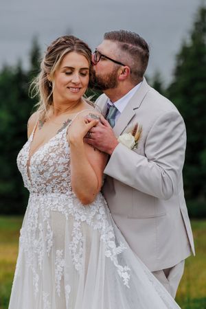 Close-up wedding photos show couple in beige suit and white lace dress sharing intimate moments in outdoor field setting.