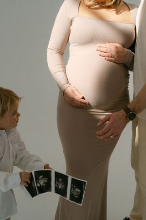 Maternity photography session featuring ultrasound photos and intimate family moments.