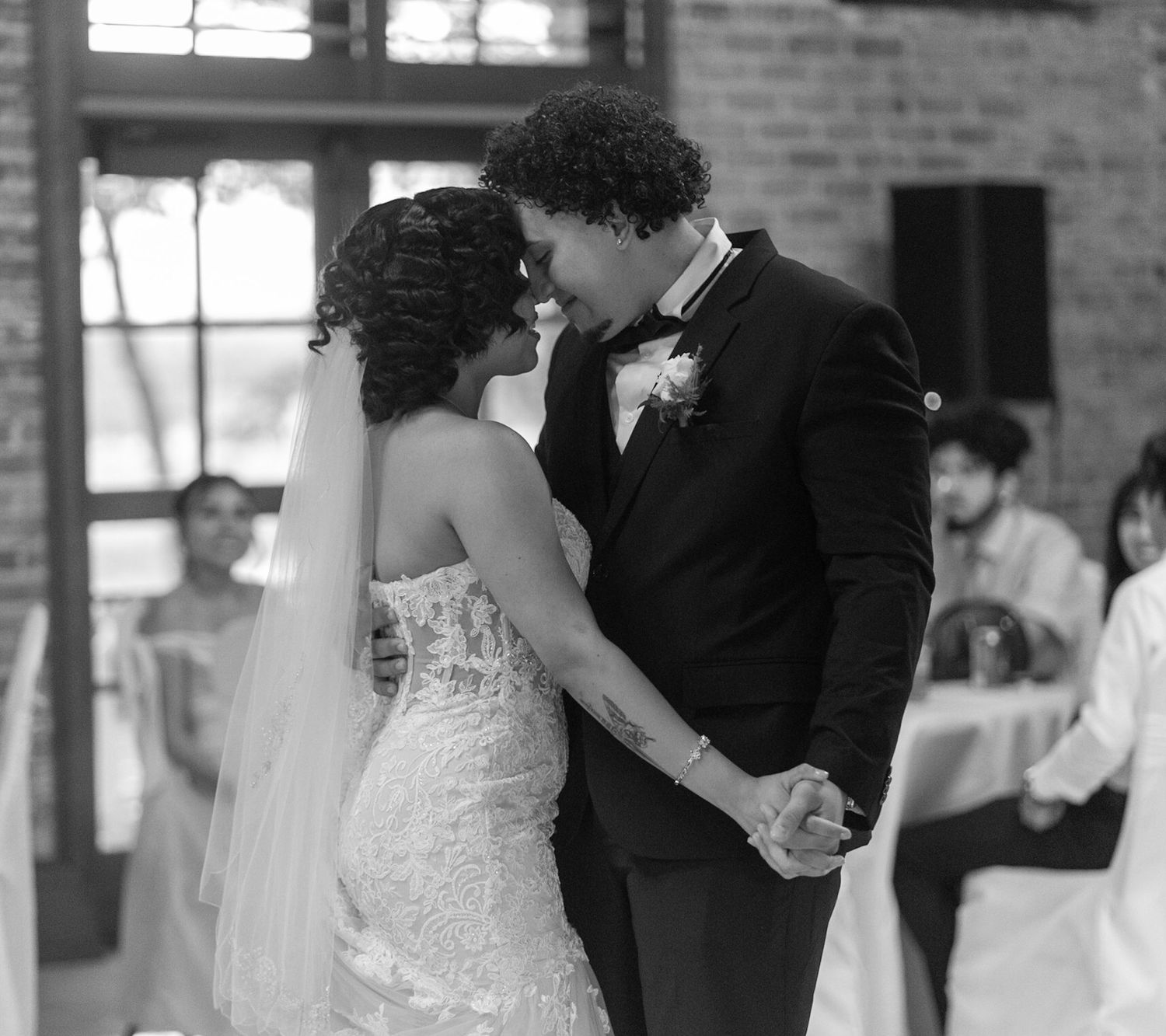 Black and white wedding dance sequence showing couple's romantic first dance in industrial venue.