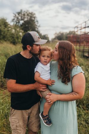 Candid family moments captured in a rustic outdoor setting with natural lighting.
