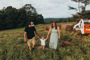 Panoramic view of family spending time together in a rural farm setting.