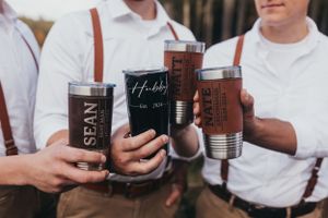 Wedding party members holding coffee mugs and drinks in an outdoor setting.