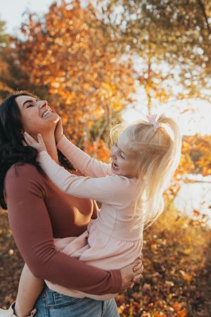 A playful autumn photoshoot sequence showing joyful interaction between two people against golden fall foliage.