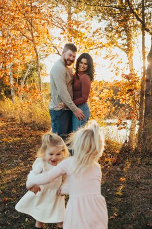 Candid family photography showing joyful moments and interactions during sunset in autumn.