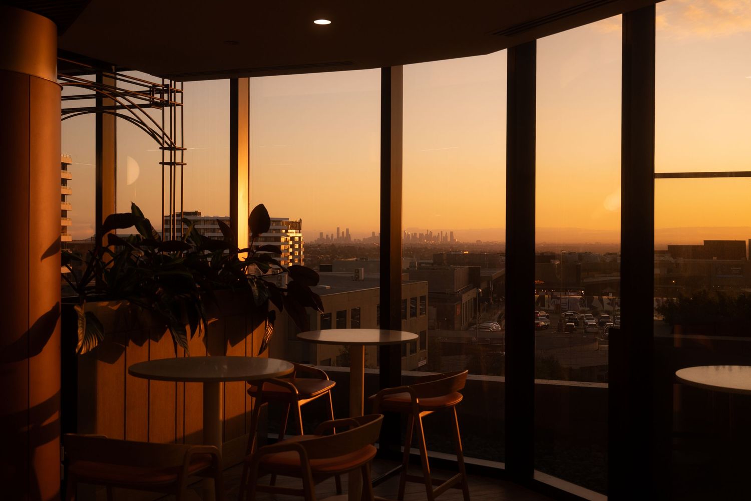 Rooftop venue photography featuring golden hour light and panoramic Melbourne skyline views