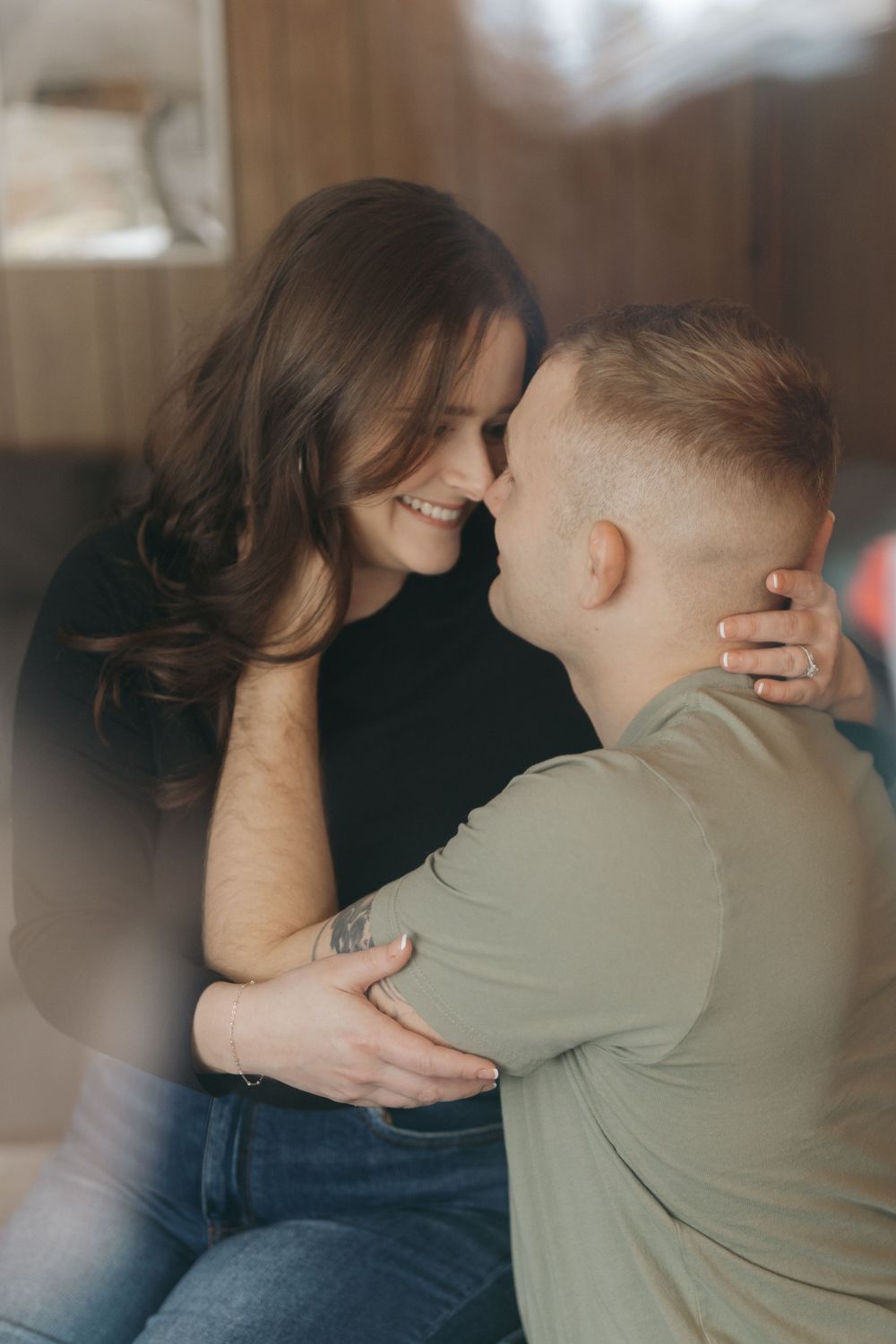 Romantic moment between couple in casual attire sharing intimate embrace.