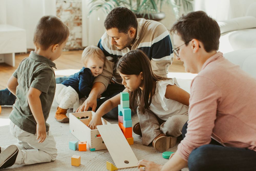 People gathered around playing board games in a bright indoor space.
