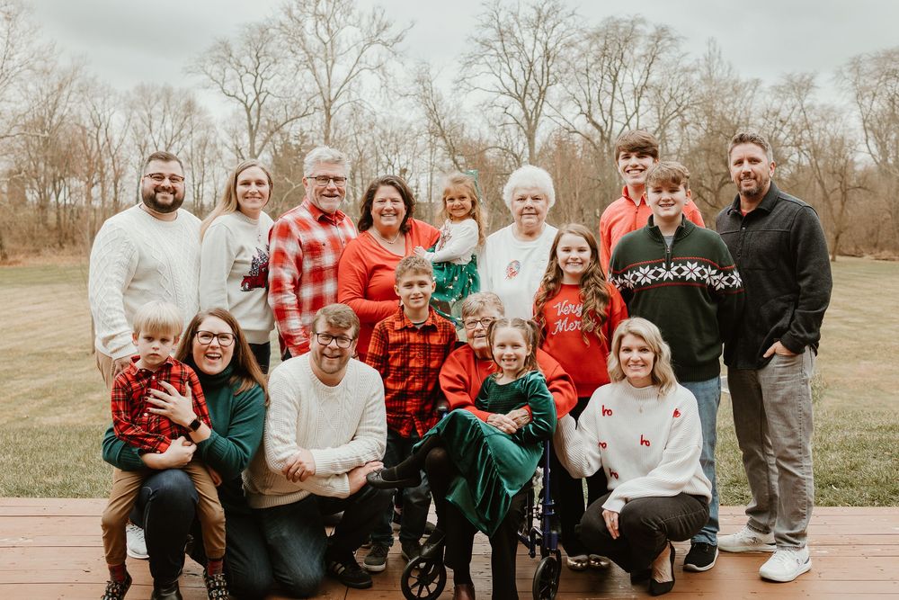 A series of outdoor family photos showing a group in coordinated red and black plaid outfits during a winter photoshoot.