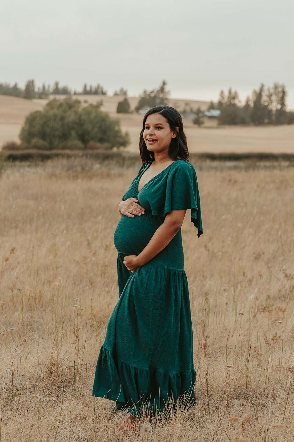 Golden hour maternity photo with Spokane maternity photographer Elishia Jackson, featuring a peaceful outdoor backdrop