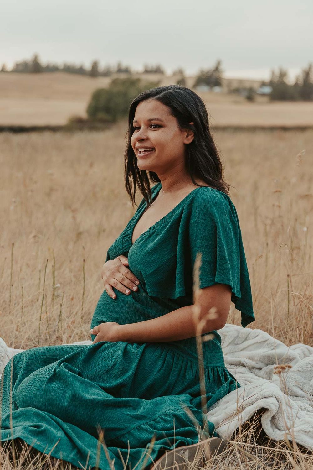 Golden hour maternity photo with Spokane maternity photographer Elishia Jackson, featuring a peaceful outdoor backdrop