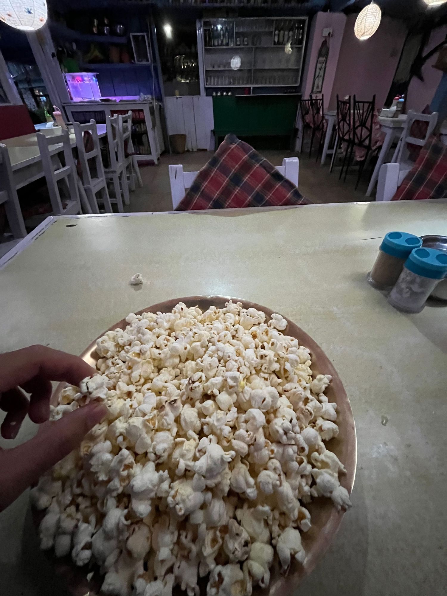 Close-up sequence showing fresh popcorn being served in a large container.