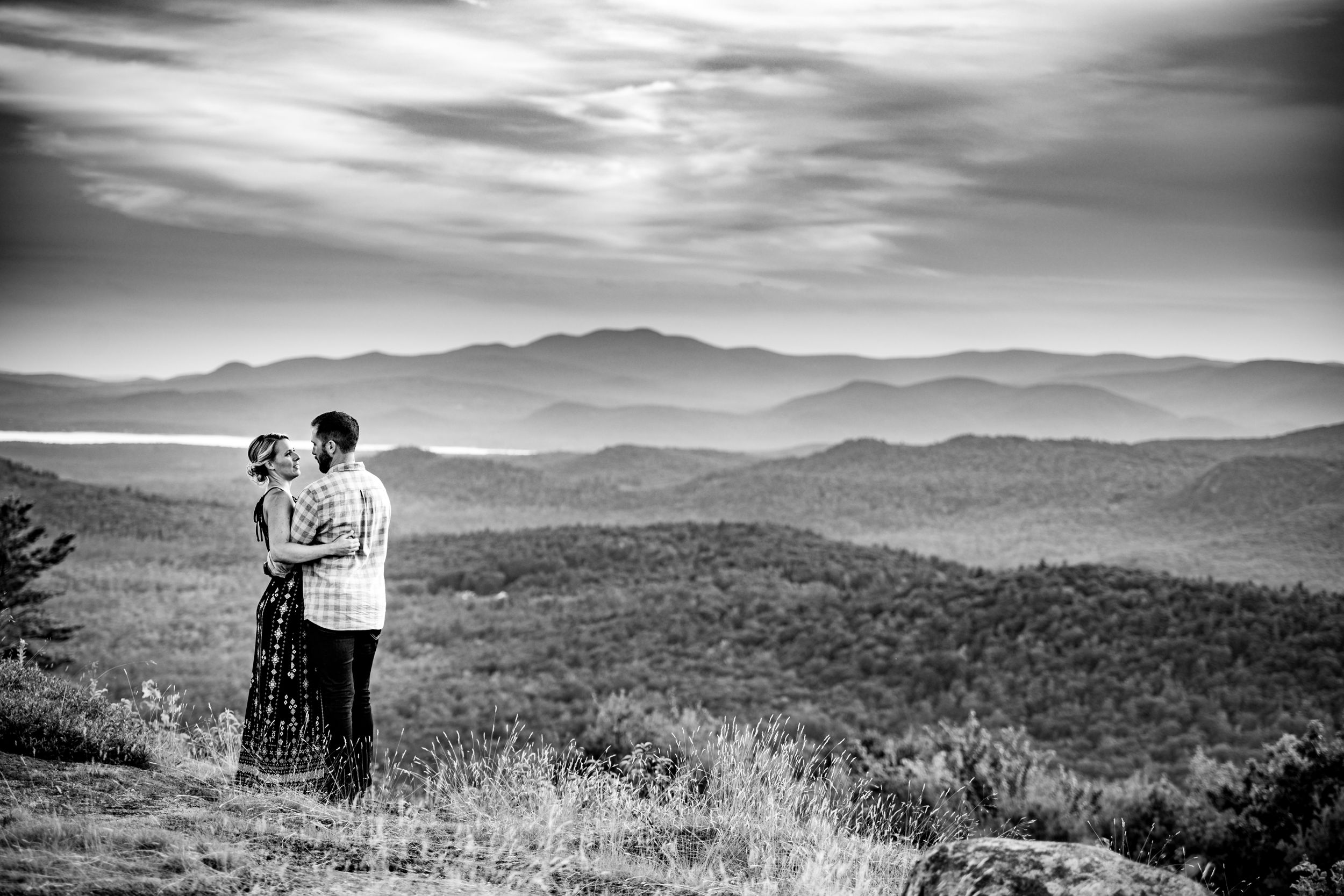 Black and white panoramic view of mountain ranges stretching to the horizon.