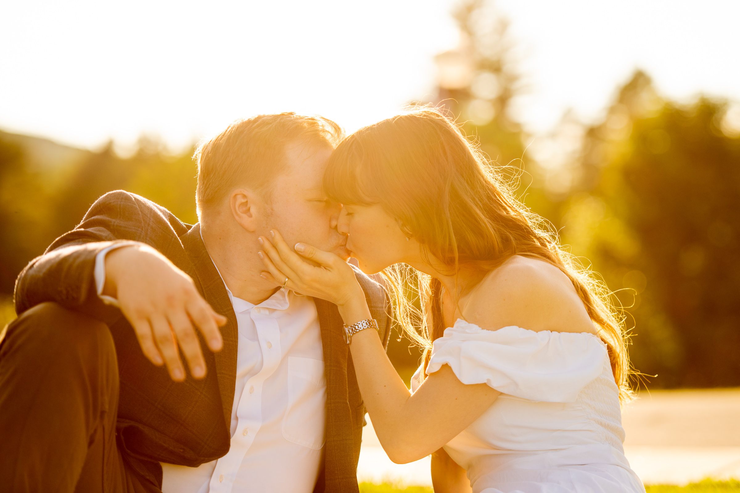 A couple shares an intimate moment during golden hour sunset photography session.
