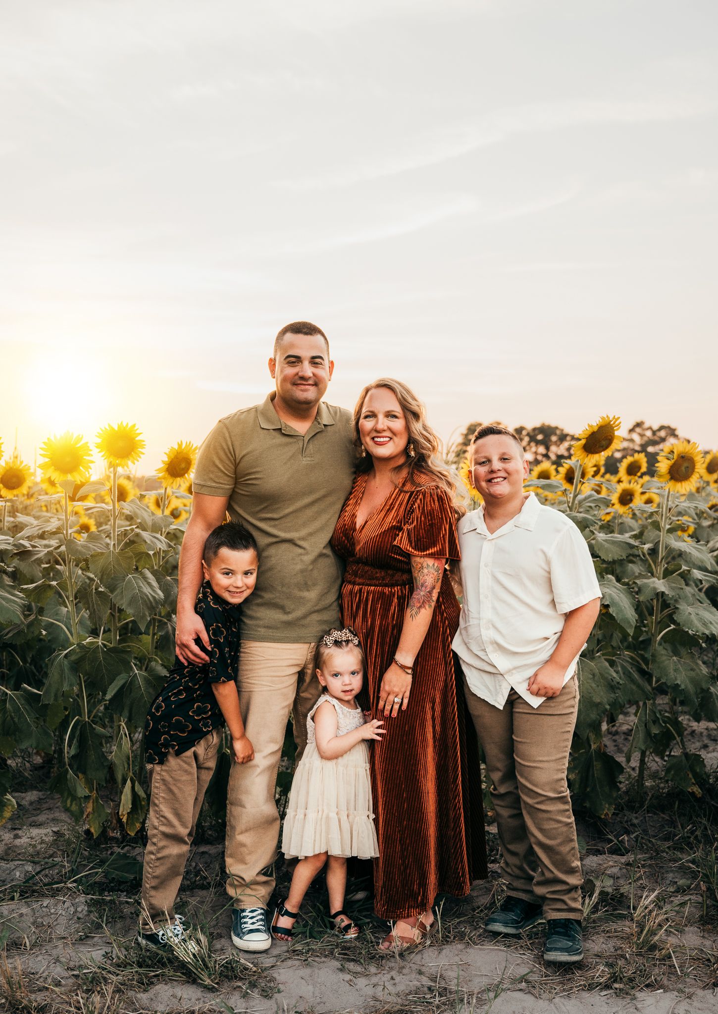 Family enjoying time together on rocky riverbank during golden hour roscoe il