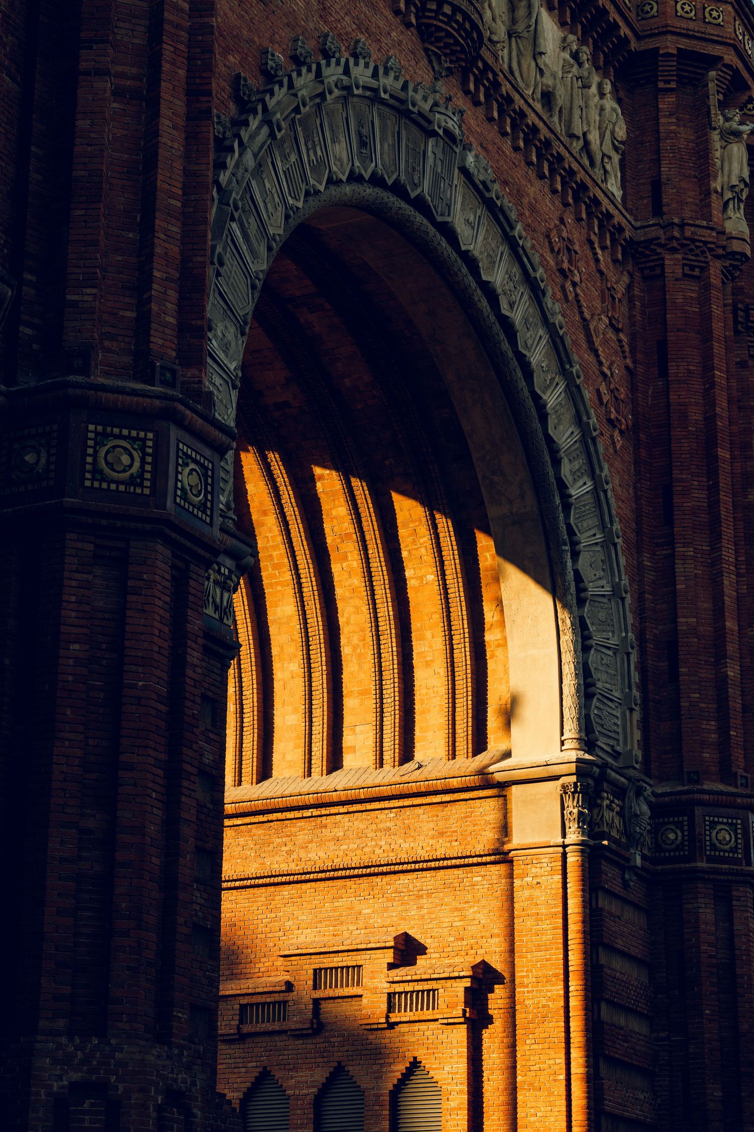 Ornate architectural arch with dramatic golden sunlight streaming through.