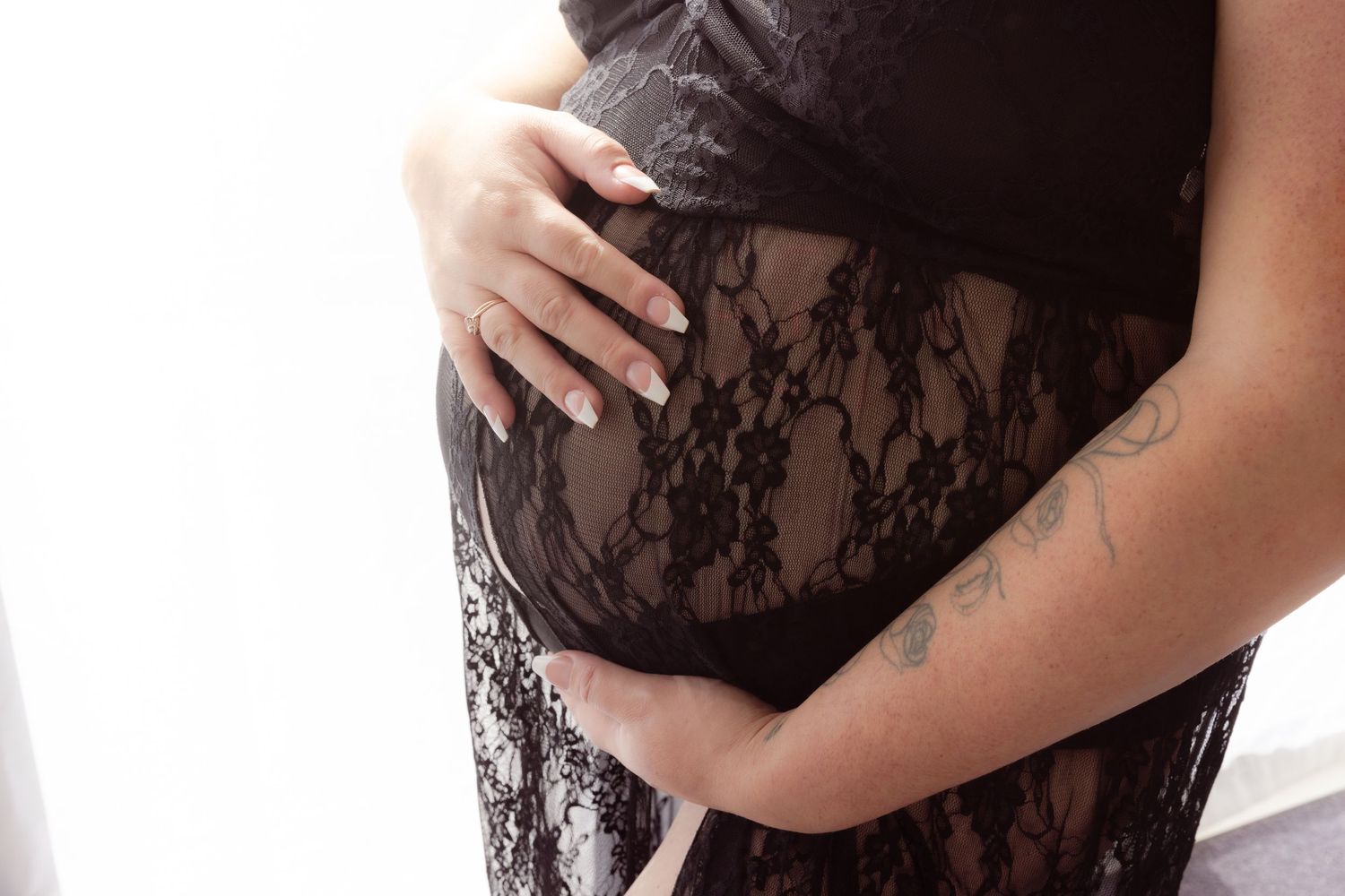 Baby bump in black lace dress