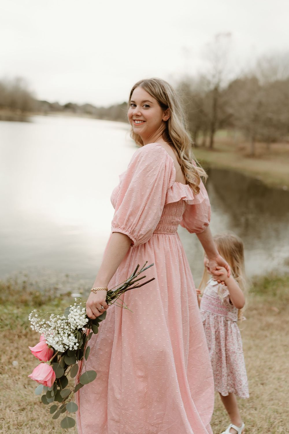 Pink-themed outdoor photoshoot with flowing dresses and fresh flowers.