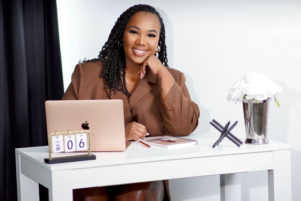 Stylish home office scene featuring brown blazer and modern white desk setup.