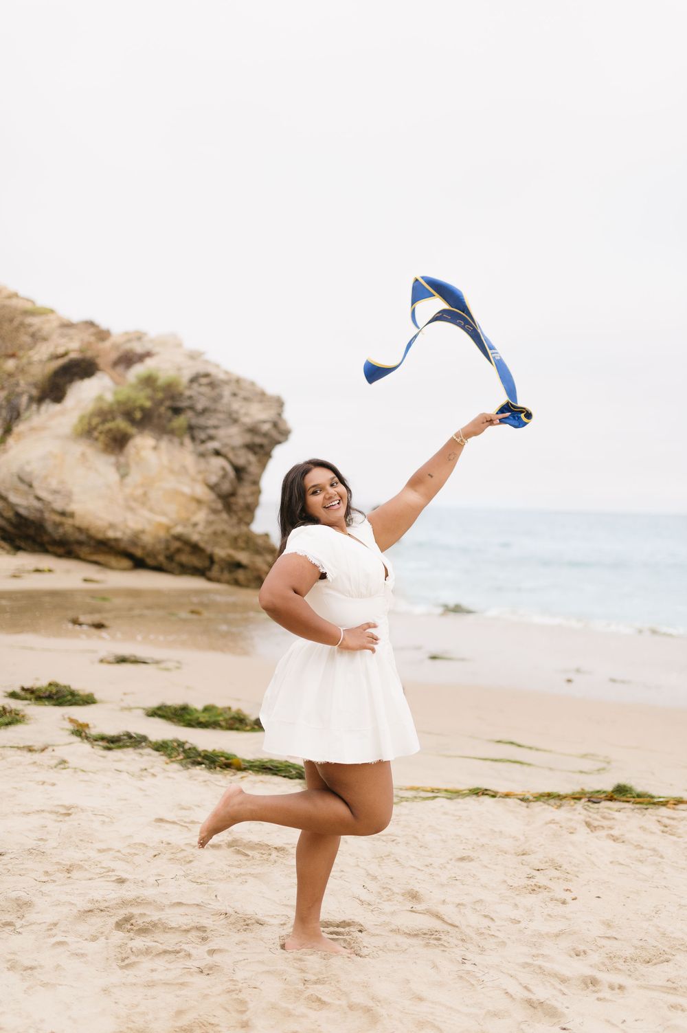 Elegant solo UCI graduation portrait at Corona del Mar Beach