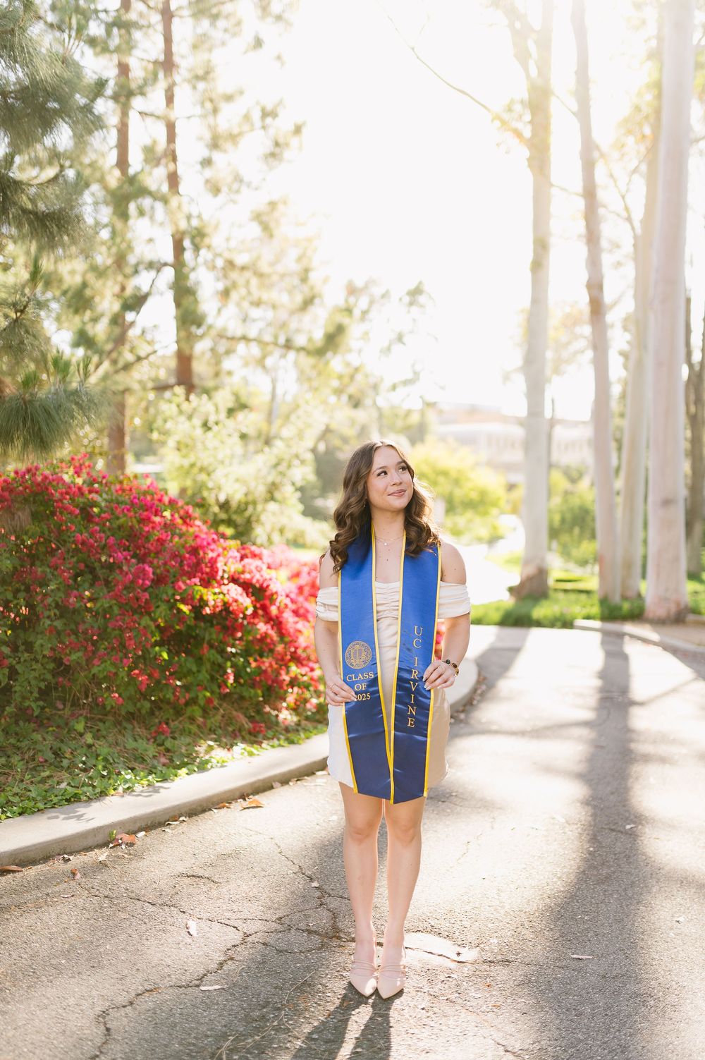 Elegant solo graduation portrait of UCI graduate on campus