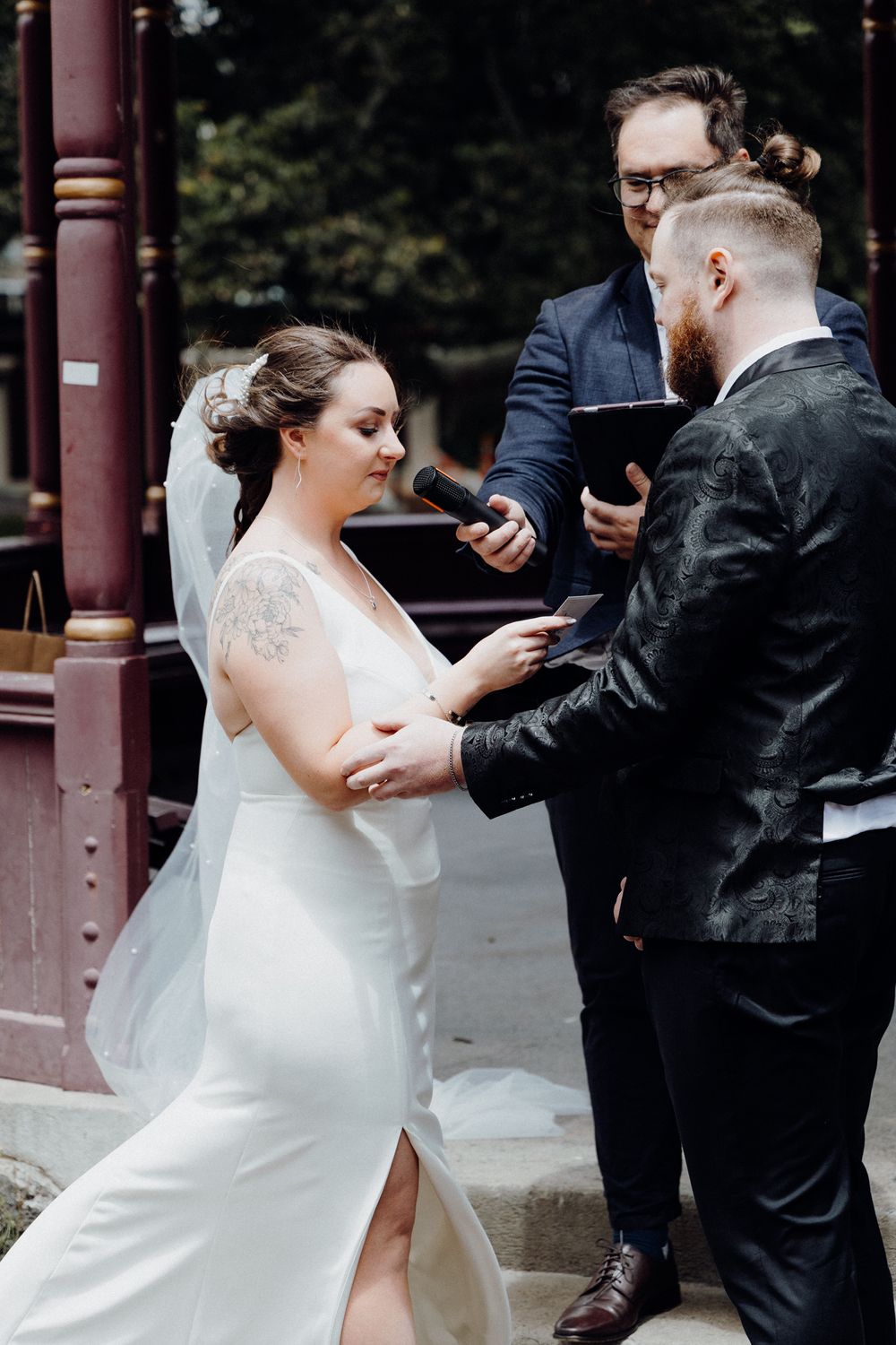 The bride and groom exchange vows, captured by Apertured Media Auckland Wedding Photographer.