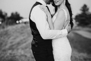 Intimate black and white portrait of couple embracing during twilight wedding photos.