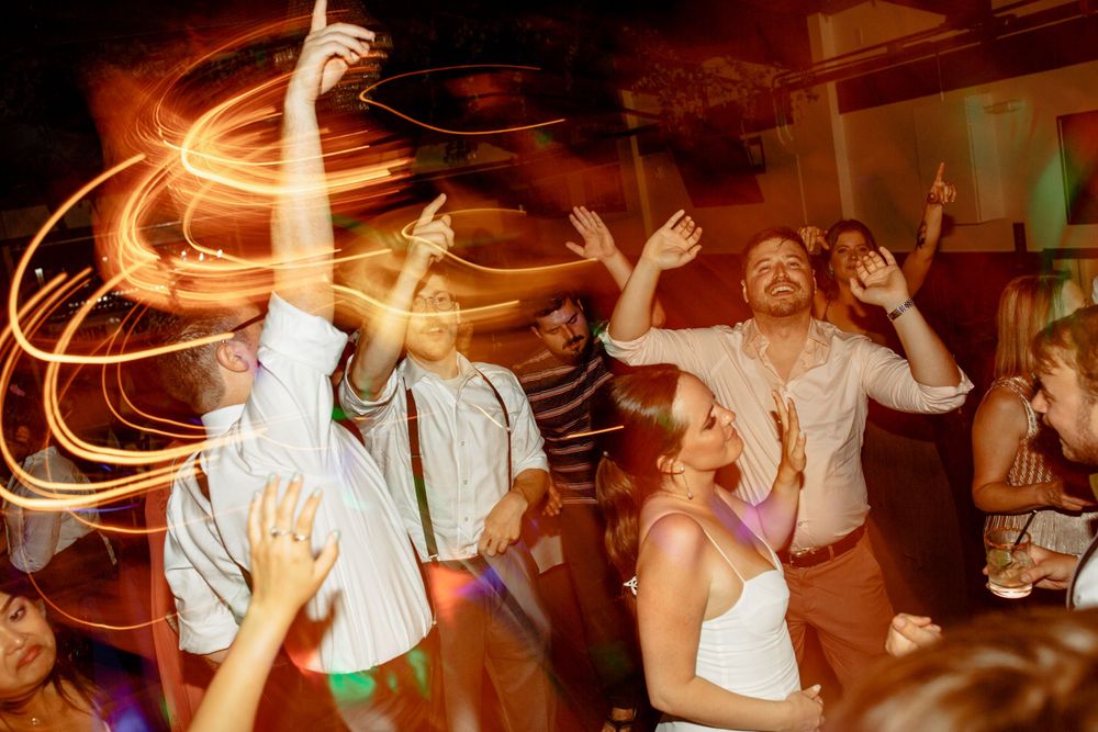 Dynamic party scene with light trails and dancing guests creating an energetic atmosphere.
