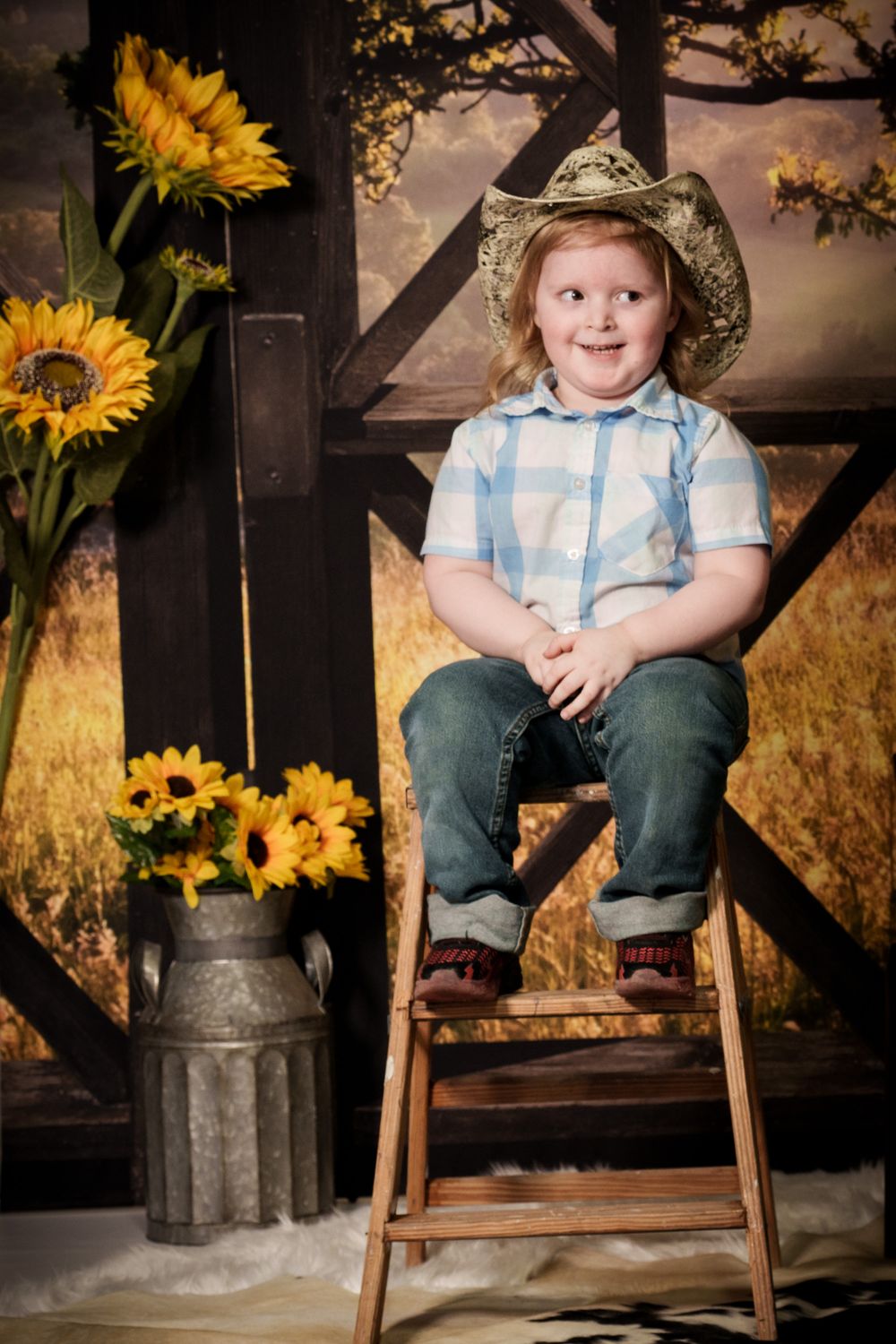 Rural country scene with sunflowers in metal milk jug and rustic wooden ladder against a warm sunset backdrop.